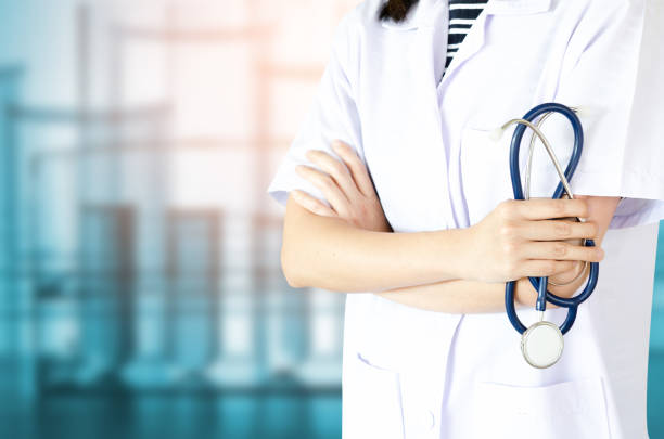 Medical physician doctor woman over blue clinic background. or lab background